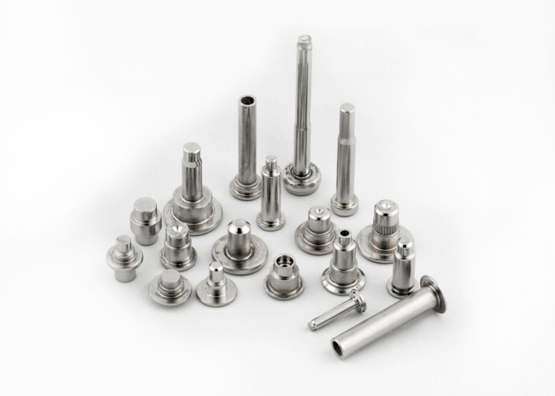 Unique shaped fasteners with offset heads and specialized configurations